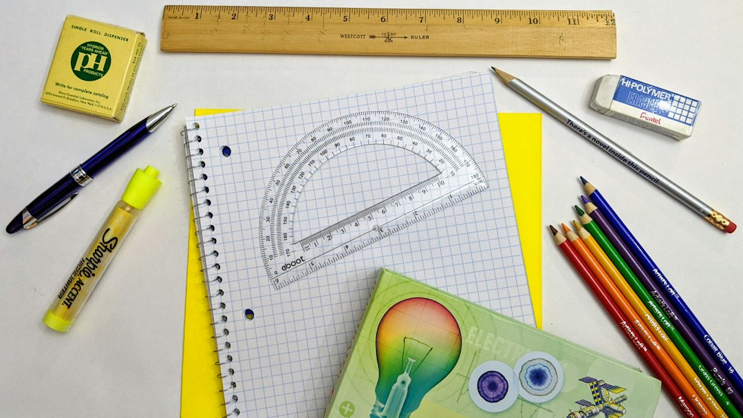Back-to-school supplies: pH strips, ruler, protractor, graph paper, yellow folder, highlighter, colored pencils, hi-polymer eraser, pencil, pen, science reference book.